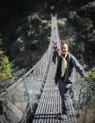 Dr. Qzgur on foot bridge to village